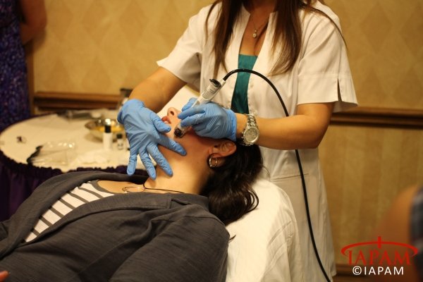 female patient receiving microdermabrasion treatment during training session