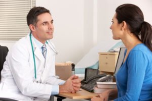 male doctor talking to female patient