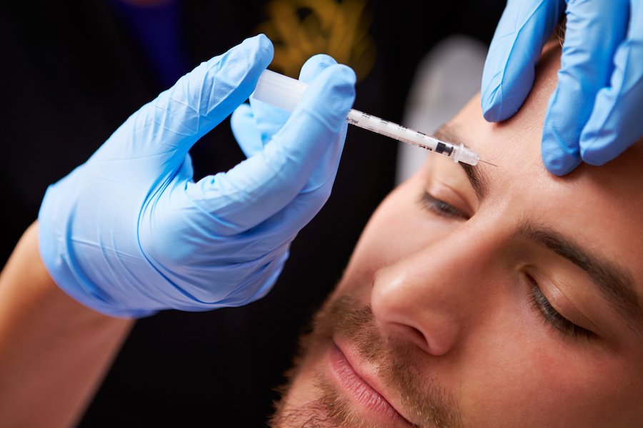 Botox injection on the brow of a male patient