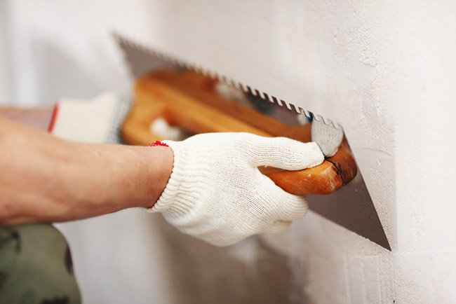 Scraping tool filling a wall