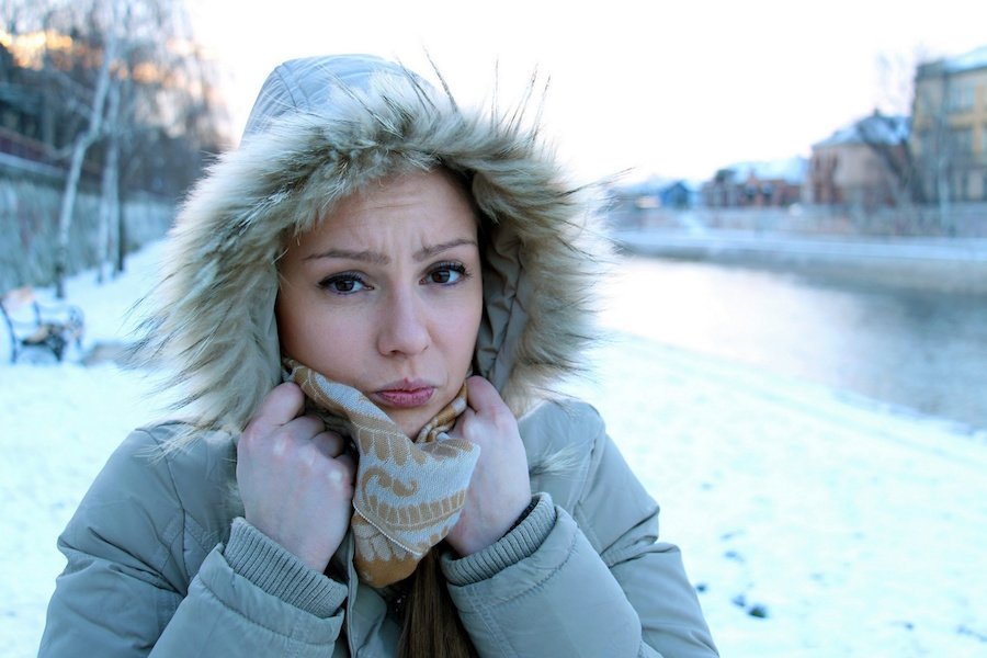 Cold woman by a frozen river