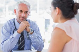 Male doctor consulting female patient in a practice office