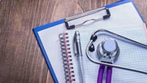 Stethoscope, notepad and clipboard