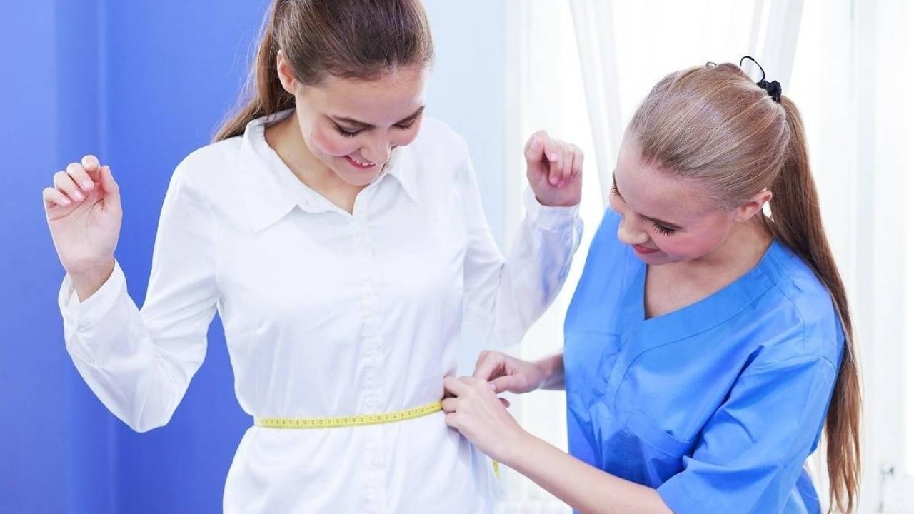 Patient getting her waist measured
