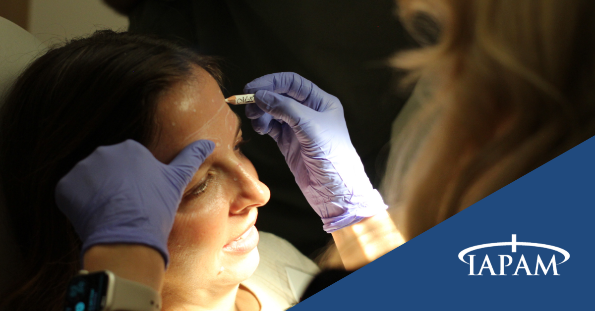 Women getting her face marked up for a Botox procedure at IAPAM's live symposium.