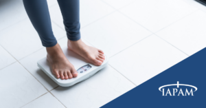 Woman standing on scale.