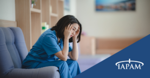 Doctor sitting on couch with her head in her hands