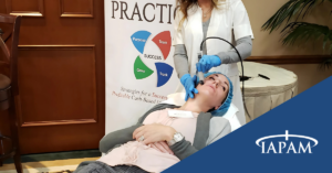Microneedling procedure at IAPAM's aesthetic medicine symposium.