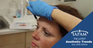 Clinician in blue gloves draws facial treatment markings on a woman's forehead; LAPAM 'Aesthetic Trends' May 2026 edition overlay in the corner.